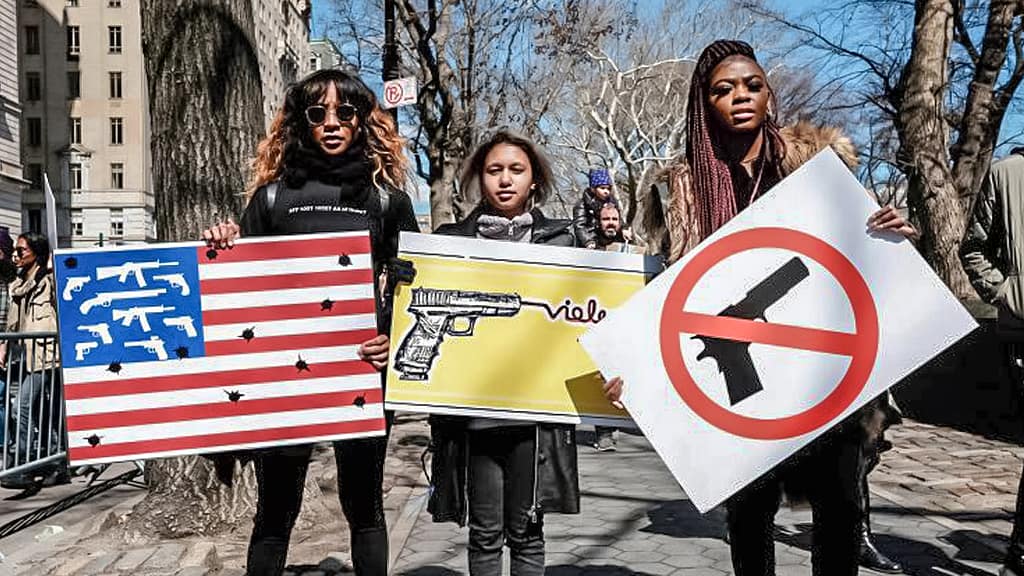 Photo: Student hold signs protesting gun violence.